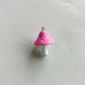 Detailed view of pink resin mushroom pendant with white dots and metal ring attachment - Pink