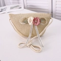 Close-up of woven straw bag with handmade fabric flowers and chic ribbon detail - Bubble Flower Style / Beige