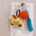 Detail of yellow fabric dog charm with orange pompom and blue rope on silver heart clasp - Little Yellow Dog