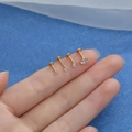 Four gold G23 titanium labrets with four different sizes of round cubic zirconia studs - Gold