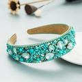 Close-up of wide headband with turquoise stones, opal crystals, and beaded trim - Cyan