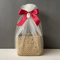 Detail of woven seagrass gift basket wrapped in white tulle with a large red satin bow - Burgundy Full Wrap Snow Mesh