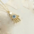 Golden Hamsa Hand necklace with blue Evil Eye pendant on minimalist thin link chain - Hamsa Hand Pendant