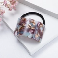 Detailed macro view of the purple marble acetate hair tie with a high elastic black band - Purple