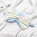 Satin sleep eye mask in light blue with a large cream silk bow and elastic strap - Mercerized Blue