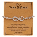 Detail of silver infinity LOVE bracelet with pavé zircons on gift card for women - Love Style (F062)