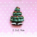 Macro detail of a 3D resin Christmas tree charm with 2.2x2.9cm dimensions for DIY crafts - Christmas Tree with Red Ribbon