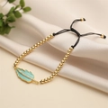 Adjustable gold bead bracelet featuring a light blue enamel leaf pendant with zircons - Green
