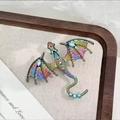 Close-up of iridescent dragon brooch with mesh wings and inlaid rhinestones details - Rainbow