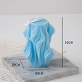 Light blue wavy sculptural scented candle with vertical pleats on a marble tray - Wave / Blue (Rosemary Mint)
