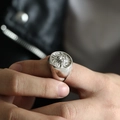 Close-up of vintage lion head seal ring on finger with detailed metallic relief - US 7 / Steel