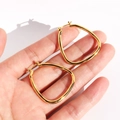 Classic gold-plated brass geometric hoop earrings with a hollow minimalist water-drop design - Gold