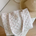 Detail of floral quilted tote bag with blue and pink flower patterns and woven label - Light Blue & Pink Small Flowers