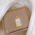 Detail of tarot card necklace showing Saturn and moon motifs on white mother of pearl - Tarot The World Style (E453)