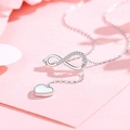 Detail of silver Y-necklace featuring a crystal infinity symbol and heart pendant - Infinity Love Zirconia Necklace - White Gold
