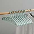 Adjustable plastic baby hangers in light blue green color hanging on a wooden rod - Adult Wide Shoulder-Blue