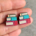 Macro shot of colorful wooden stud earrings featuring a stacked book design for teachers - Book Stack Design