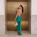 Detail of emerald green backless dress with ruched waist and thin straps in a luxury setting - S / Green