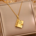 Close-up of gold book locket necklace with My Little Star engraving on jewelry cushion - 12 Gold Daughter Style Necklace