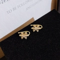 Exquisite gold snowflake ear cuffs with sparkling white zircons on a black display - 30045-Gold Rhinestone Snowflake Pair