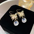 Eleganti orecchini a farfalla dorati con pietre di zircone e cristalli a goccia - Lunga Frangia con Fiocco Tutto Diamanti Argento (E0255)