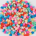 Close-up of colorful paw-shaped clay spacer beads for DIY jewelry making - Footprint