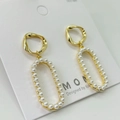 Detailed macro view of S925 silver needle pearl earrings with twisted gold hoops - Twisted Loop Pearl Inlay Earring