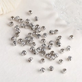 Detailed close-up of silver-plated spiral-textured round spacer beads for jewelry making - 3mm / White Gold