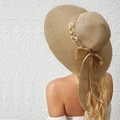Close-up of khaki straw sun hat featuring elegant white flowers and pearl embellishments - M (56-58cm) / Khaki