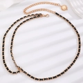 Detail of elegant gold metal chain and black leather woven waist belt with coin charm - Gold Black Leather Braided Chain (S158)