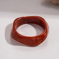Macro shot of irregular wavy resin bangle with marbled amber red texture on white surface - Amber Red Irregular Twisted Wave Style (3#)