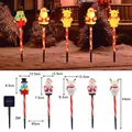 Solar Christmas path lights set featuring snowman and santa claus garden decorations - Multicolor
