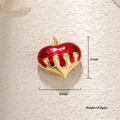 Macro view of 20mm red enamel heart pendant with melting gold-plated drip detail - Medium Lava 3D Heart