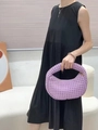 Detailed close-up of lavender woven leather crescent bag texture and metal zipper - Purple