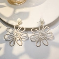 Macro detail of hand-woven cream raffia flower earrings on a white minimalist plate - White