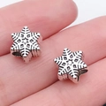 Set of two silver snowflake charms for DIY jewelry making shown on a finger for scale - 1pc Christmas Snowflake Bead (Small)
