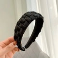 Close-up of a handmade black woven wide headband with textured satin fabric detail - Black