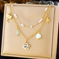 Detail of a layered ocean necklace featuring starfish, pearls, and a blue bear charm - Ocean and Animal Multi-Pendant Style (N3360)
