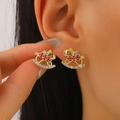 Golden rocking horse earrings with red enamel and white crystals shown on an ear - Rocking Horse Red Enamel Style / 14k Light Gold Rocking Horse Red Enamel Style (6253)