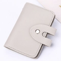 Light gray pebbled leather card holder with minimalist fold design and silver snap button - Gray