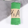 Bright green cotton linen scarf roll with brown paper sleeve packaging on fur mat - Grass Green / One Size