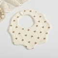 Petal-shaped muslin baby bib in cream with brown heart pattern and snap closure - Brown Heart
