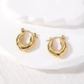 Detail view of gold-plated geometric U-shaped hoop earrings with polished bamboo texture - Teardrop
