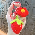 Handmade crochet strawberry and flower keychain with a red metallic keyring accessory - Red Strawberry Flower