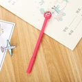 Pink cartoon neutral pen featuring a cute 3D strawberry charm on a desktop - Strawberry Gel Pen