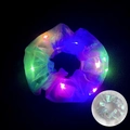 Close-up of glowing LED mesh scrunchie in the dark and silver appearance in daylight - Iridescent Silver
