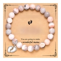 Detailed view of pink stone beaded bracelet with silver baby feet charm on a gift card - Pink Zebra Baby Feet Bracelet