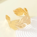 Detailed macro view of a gold leaf-shaped open cuff bracelet with metallic finish - 1082-Realistic Metal Leaf Shaped Cuff