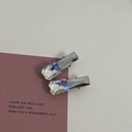 Close-up of silver-tone alloy hair clips with iridescent rectangular crystals on purple card - Silver/White Zirconia-Small Rectangle