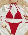 Red ribbed halter bikini set with tie-up bottoms on a summer vacation beach setting - Red
